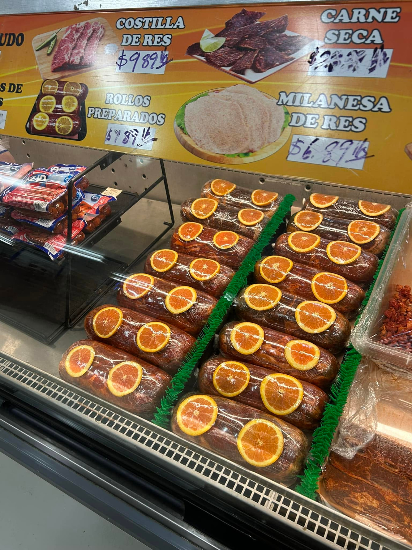 Carnicería case of house-prepared meat rolls at Jake's Meats in Quincy, WA