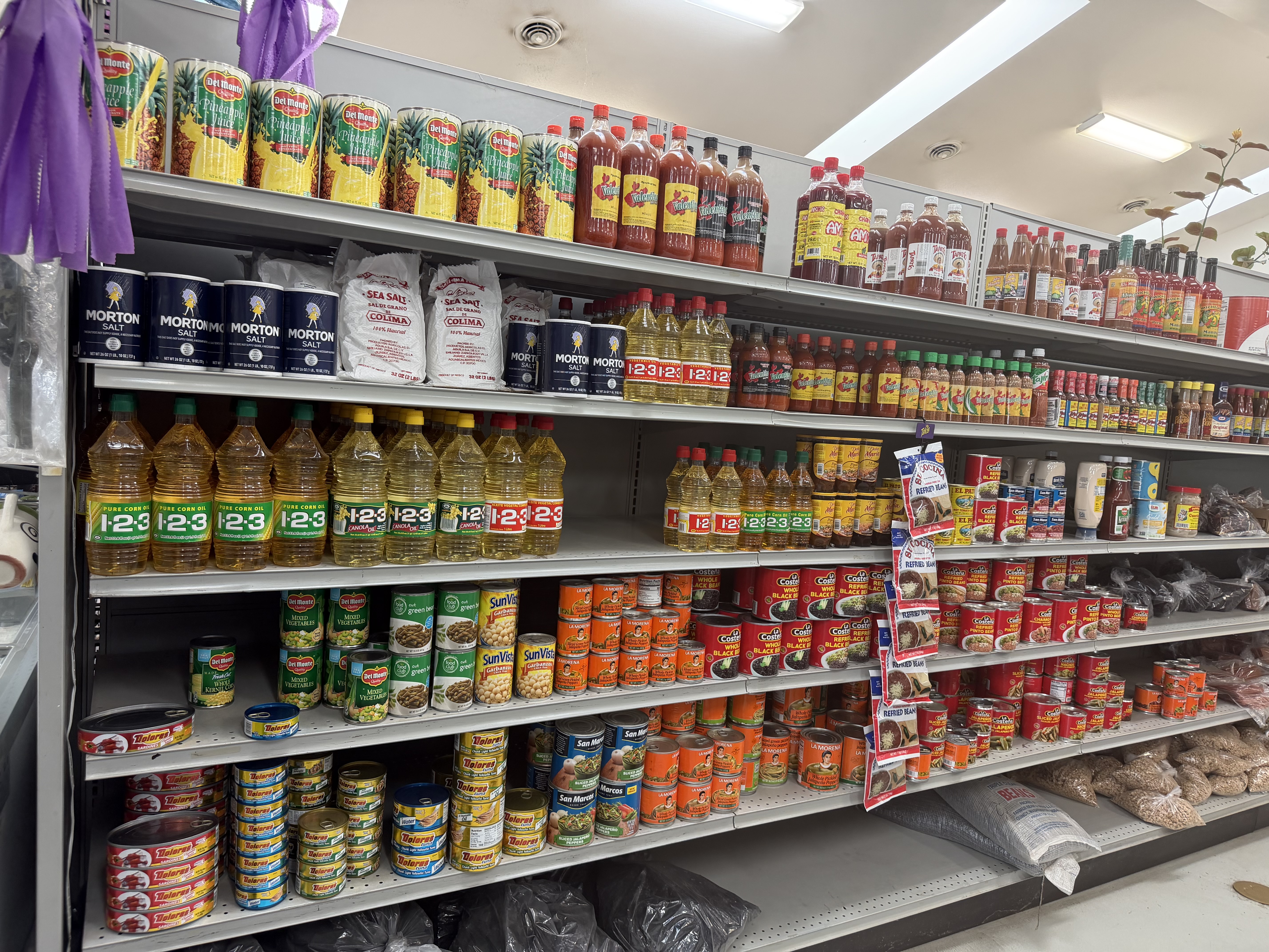 Canned goods, cooking oil and hot sauce shelves