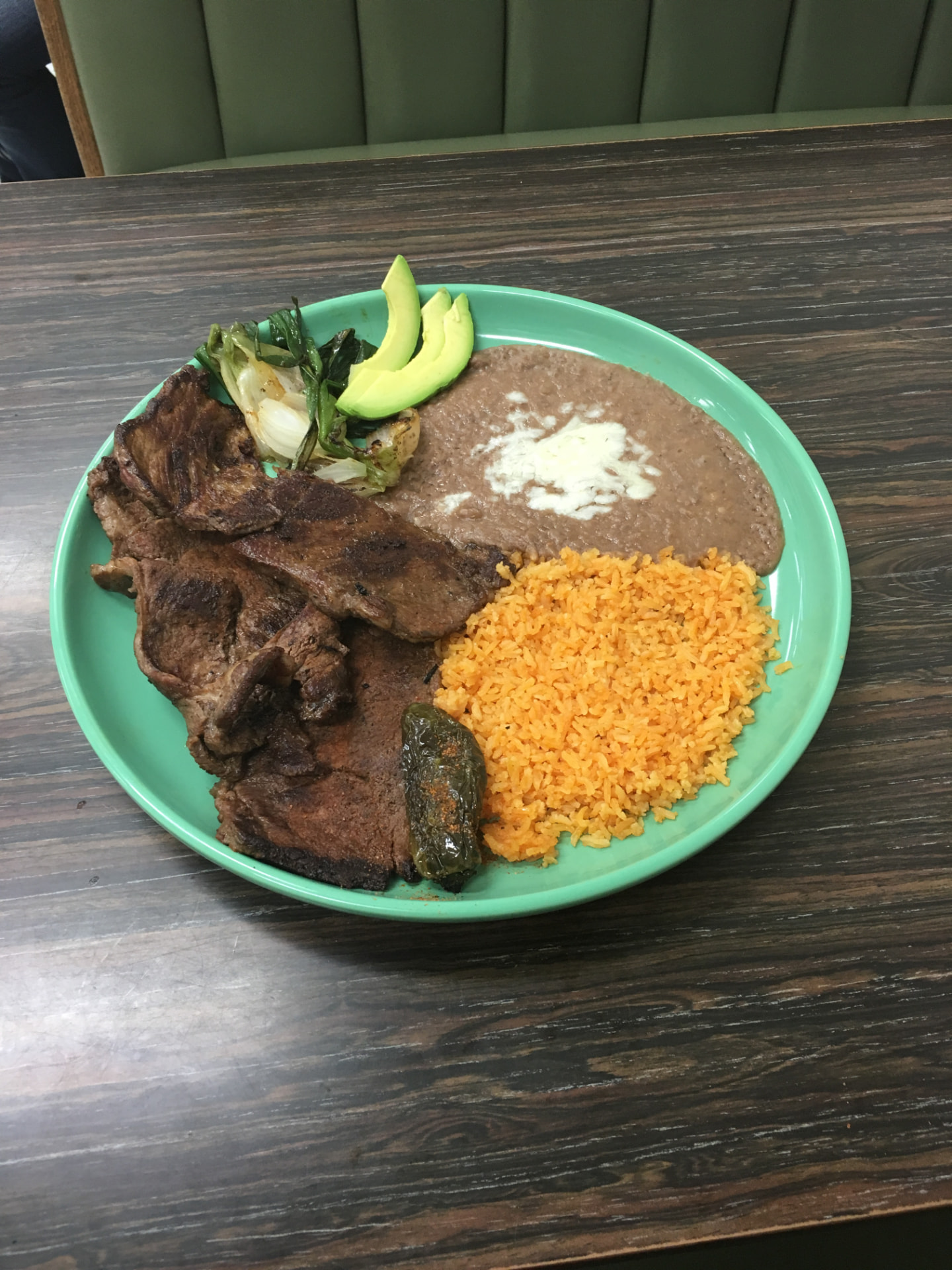 Carne asada plate with grilled onions, jalapeño, Mexican rice and refried beans at Jake's Meats